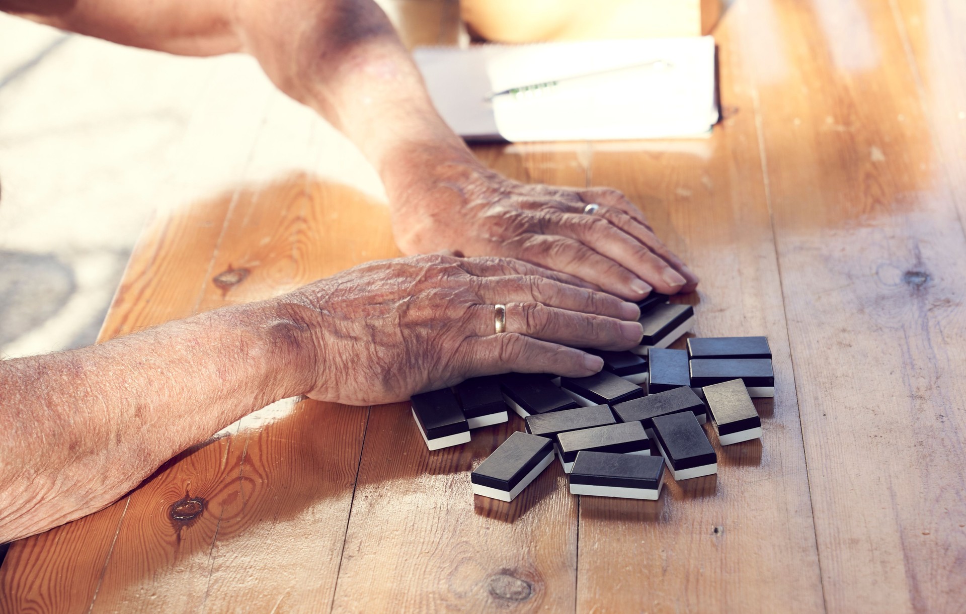A family playing domino game in a wooden table